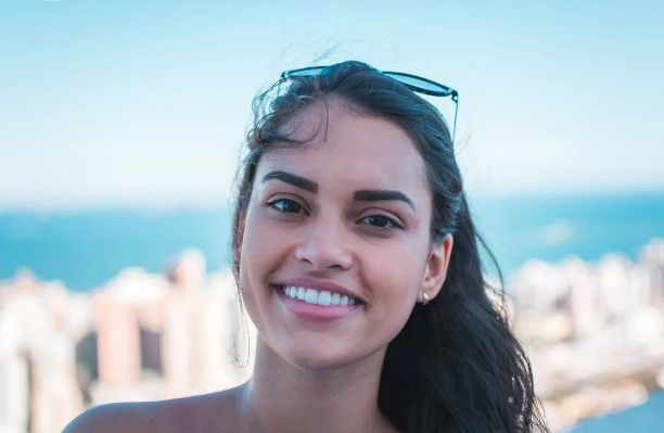 Smiling Woman Wearing Sunglasses at the Beach